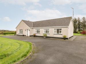 a house with a driveway in front of it at Dromore West Cottage in Dromore West