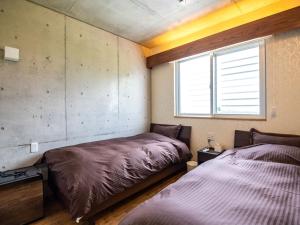 Katil atau katil-katil dalam bilik di Kugani-YA.