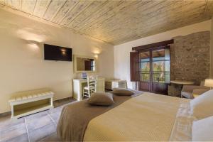 a bedroom with a large bed in a room at Castello Antico Hotel in Gythio
