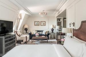 a bedroom with a bed and a living room at The Langham London in London