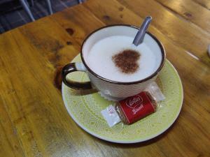 a cup of coffee on a plate on a table at Woolpack Inn in Chichester