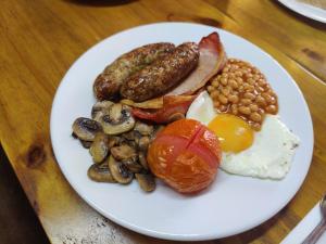 a plate of food with eggs sausage beans and bacon at Woolpack Inn in Chichester