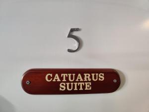 a sign on a wall with the number three at Woolpack Inn in Chichester
