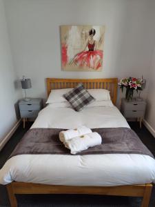 a bedroom with a bed with two towels on it at Woolpack Inn in Chichester