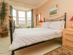 a bedroom with a bed and a window at Penryn in Ilfracombe