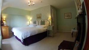 a bedroom with a large white bed in a room at Wood House in Cockermouth
