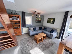 a living room with a couch and a table at Beautifull house Beach Life 47 in De Cocksdorp +5 photos