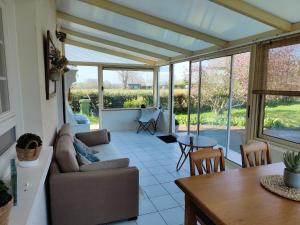 a living room with a couch and a table at Le Gîte d'Odette in Dampierre-sous-Bouhy +21 photos