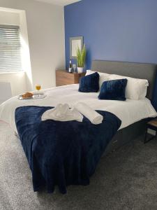 a bedroom with a large bed with two towels on it at HU-Thirteen Apt One - Sleeps 4 in Hessle