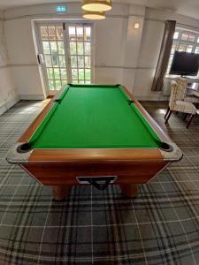 a pool table in a room with a green at Woolpack Inn in Chichester