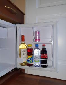 an open refrigerator filled with bottles of alcohol at Virág Panzió in Lupeni