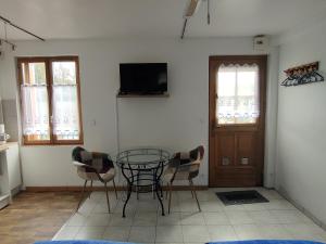 a dining room with a glass table and chairs at Studio à la mer in Criel-sur-Mer