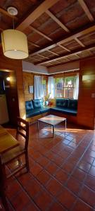 a living room with a couch and a table at Cabañas Matilde 1 in San Martín de los Andes