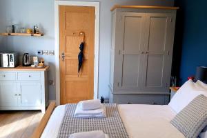 a bedroom with a bed with towels on it at Stylish coastal retreat in St Ives in Carbis Bay