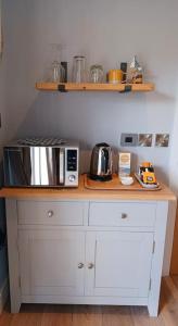 a kitchen with a counter top with a microwave at Stylish coastal retreat in St Ives in Carbis Bay