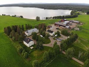 an aerial view of a house on a field next to a lake at Malgomajgården 1 in Vilhelmina