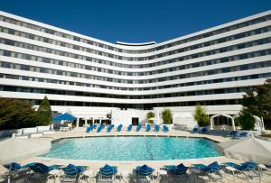 a large building with chairs and a swimming pool at Washington Plaza Hotel in Washington