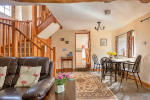 a living room with a couch and a table at Finest Retreats - Fives Court Cottage in North Cheriton