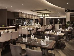 a restaurant with tables and chairs and a bar at TQT Hotel in Hanoi