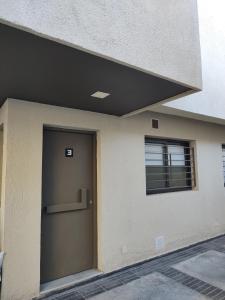 a building with a door and a window at 787 Suites in La Cieneguita