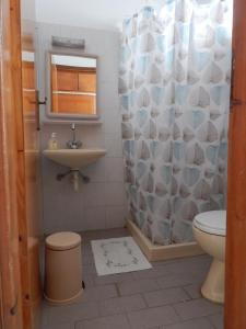 a bathroom with a toilet a sink and a shower at POLITIS STUDIOS in Kefalos