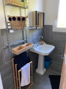 a bathroom with a sink and a toilet and a mirror at Appartement verrière à deux pas des plages… in Hyères