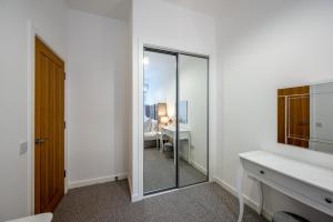 a white bathroom with a mirror and a desk at Casa Fresa - Seamen's Chapel in Dundee +24 photos
