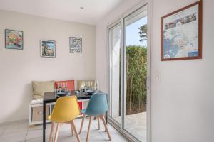 a dining room with a table and two chairs at Nid douillet pour 3 à 100m de la mer in La Plaine-sur-Mer
