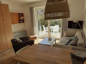 a living room with a couch and a table at Wattwurm in Wangerooge