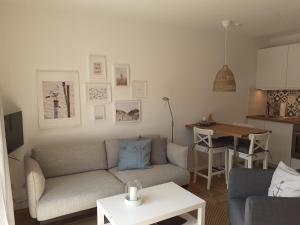 a living room with a couch and a table at Wattwurm in Wangerooge