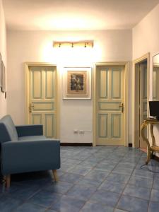 uma sala de estar com duas portas e um sofá azul em Casa vacanza maronti em Ischia