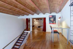 a living room with a wooden floor and a ceiling at Friendly Rentals Monet in Barcelona
