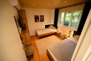 a living room with a couch and a window at Ferienhaus Haus im Garten in Feldkirch