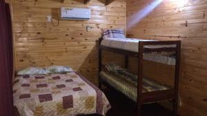 a bedroom with two bunk beds in a cabin at BUGANVILIAS LODGE in Puerto Iguazú +31 photos