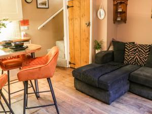 a living room with a couch and a table at Black Gem Cottage in Whitby