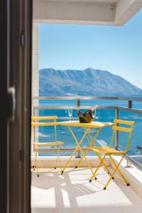 a table and chairs on a balcony overlooking the ocean at Fontana Residence Budva in Budva