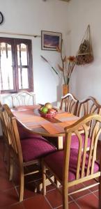 a dining room table and chairs with a table at CABAÑA RURAL SANTMARTIN in Sutamarchán