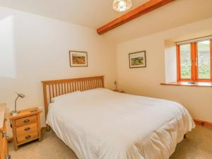 En eller flere senge i et værelse på Curlew Cottage