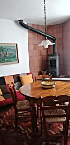a dining room with a wooden table and chairs at Casa Perni in Buccheri