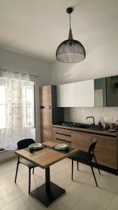 a kitchen with a wooden table and a dining room at Acquamarina in Crotone
