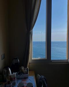a view of the ocean from a window at Le Storie di Manarola in Manarola