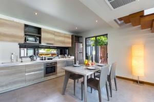 a kitchen with a table and chairs in a room at Villa Crystal Two-bedroom private pool villa in Phuket