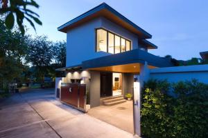 a blue house with a large window at Villa Crystal Two-bedroom private pool villa in Phuket