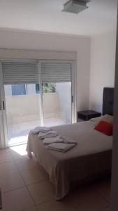 a bedroom with a bed and a large window at Departamentos VM in Villa María