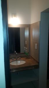 a bathroom with a sink and a mirror at Departamentos VM in Villa María