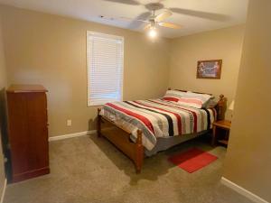 a bedroom with a bed and a ceiling fan at Windrock Retreat in Oliver Springs