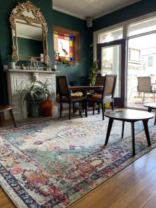 a living room with a table and chairs and a rug at Somerset House Inn in Provincetown