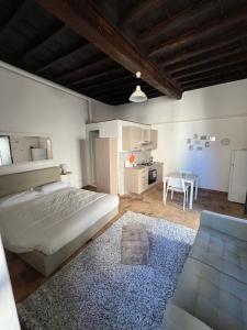 a bedroom with a bed and a table in it at La Bracceschina Appartamenti in Spoleto +32 photos