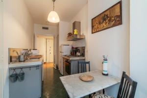 a kitchen with a table and a counter top at Cipro Apartment with balconies in Rome