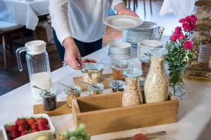 a person preparing food on a table with a box of food at Hotel Garni Schmieder’s Ochsen in Seelbach